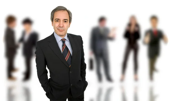 Mature business man portrait with some in the back — Stock Photo, Image