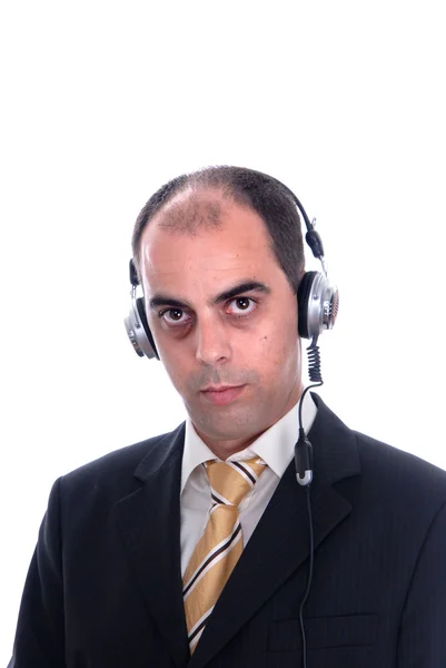 Hombre de traje de negocios escuchando música en auriculares — Foto de Stock