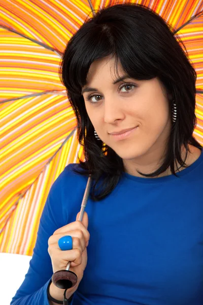 Young brunette girl with umbrella in colors — Stock Photo, Image