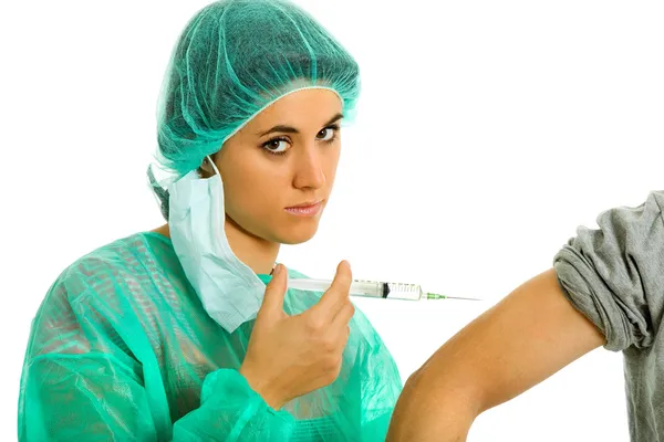 Young woman nurse with a syringe and a male patient arm — Stock Photo, Image