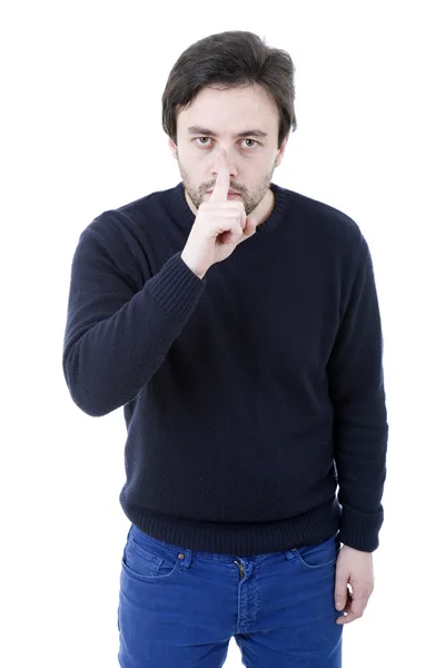 Jeune homme montrant un geste de silence avec le doigt dans la bouche — Photo