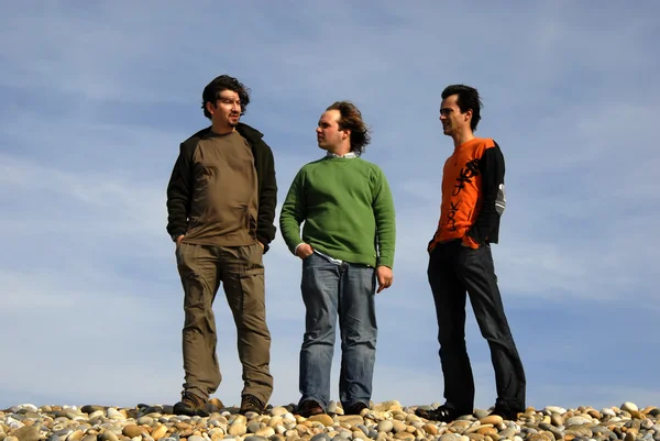 Three casual young men at the beach — Stock Photo, Image