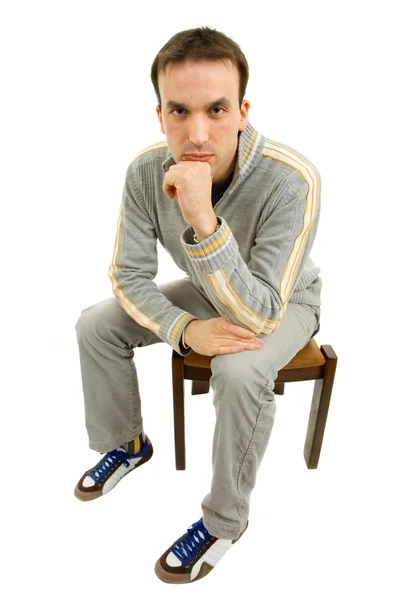 Young casual man on a chair, isolated on white — Stock Photo, Image