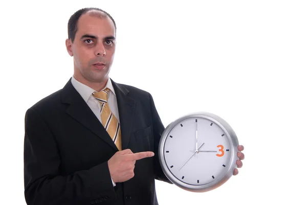 Un bel homme d'affaires tenant une horloge — Photo