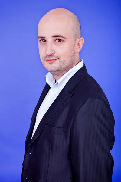 Young casual happy man, on a blue background — Stock Photo, Image