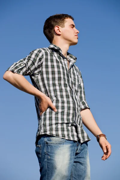 Young casual man with the sky as background — Stock Photo, Image
