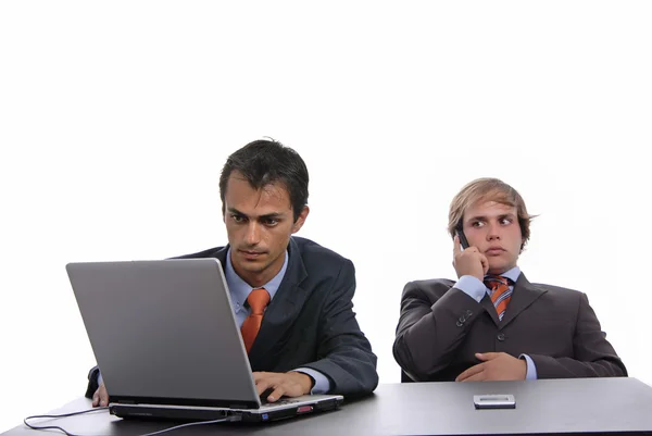 Два молодых бизнесмена, работающие с ноутбуком — стоковое фото