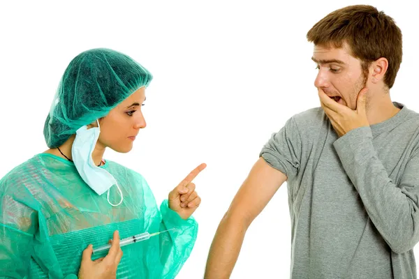 Young woman nurse with a syringe and a male patient — Stock Photo, Image