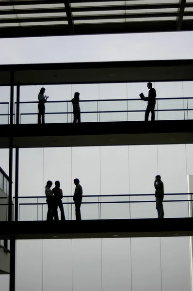 Arbeiter im Bürogebäude und am Himmel — Stockfoto