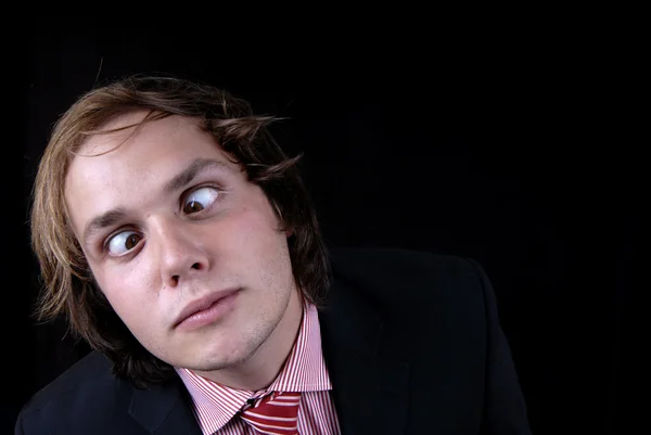 Crazy young man portrait isolated on black — Stock Photo, Image