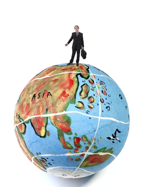 Young business man in the top of a globe — Stock Photo, Image