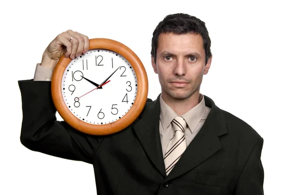 Joven hombre de negocios guapo sosteniendo un reloj — Foto de Stock