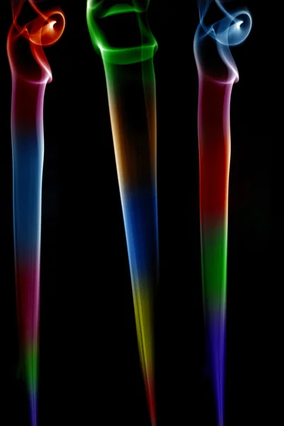 Colored smoke lines in a black background — Stock Photo, Image