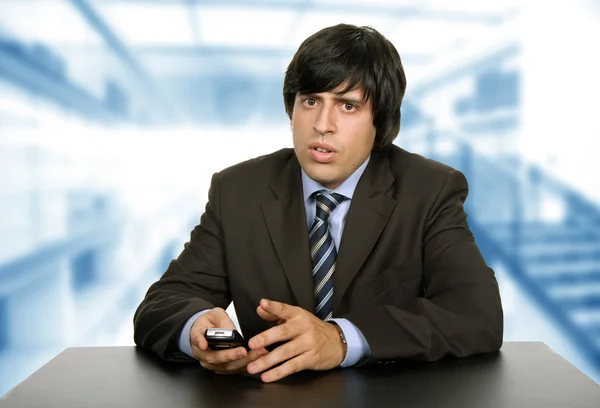 Young worried business man on a desk — Stock Photo, Image