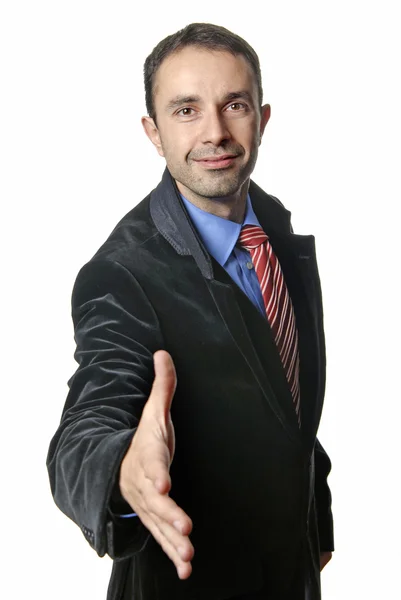 Young man in suit offering to shake the hand — Stock Photo, Image