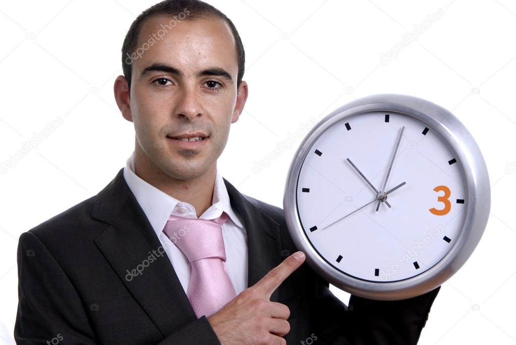 Handsome business man holding a clock