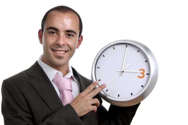 Young handsome business man holding a clock — Stock Photo, Image