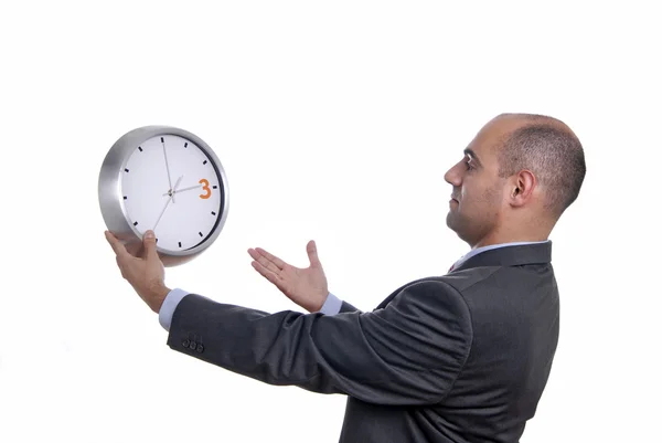 Handsome business man holding a clock — Stock Photo, Image