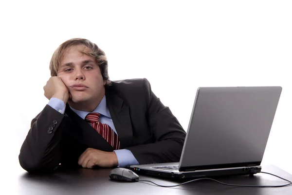 Young bored business man working with is laptop — Stock Photo, Image