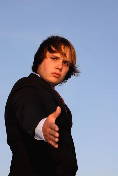 Young man offering hand — Stock Photo, Image