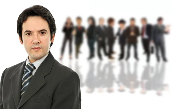 Young business man in front of a group of — Stock Photo, Image