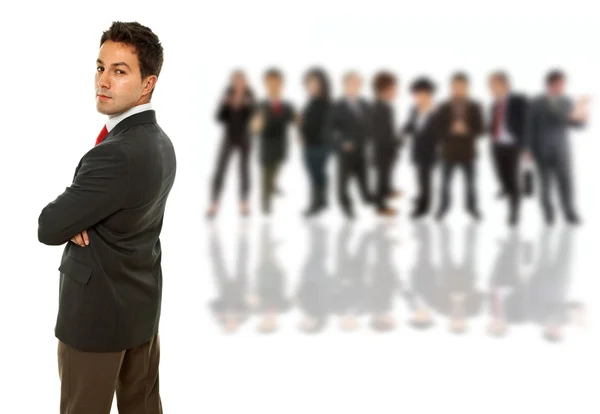 Young business man in front of a group of — Stock Photo, Image