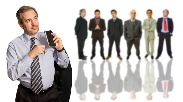 Mature business man in front of a group of — Stock Photo, Image