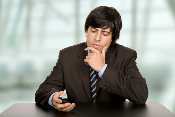 Young worried business man, on a desk