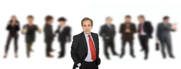 Mature business man with workers in the back — Stock Photo, Image