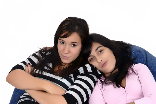 Two young girls in a sofa — Stock Photo, Image