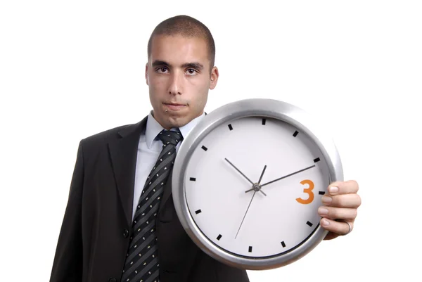 Joven hombre de negocios guapo sosteniendo un reloj — Foto de Stock