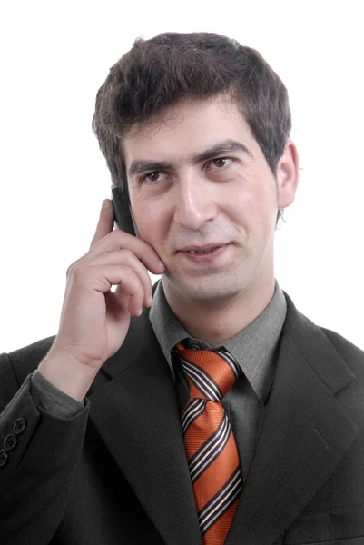 Junger Mann am Telefon vor weißem Hintergrund — Stockfoto