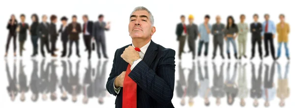 Mature business man in front of a group of — Stock Photo, Image