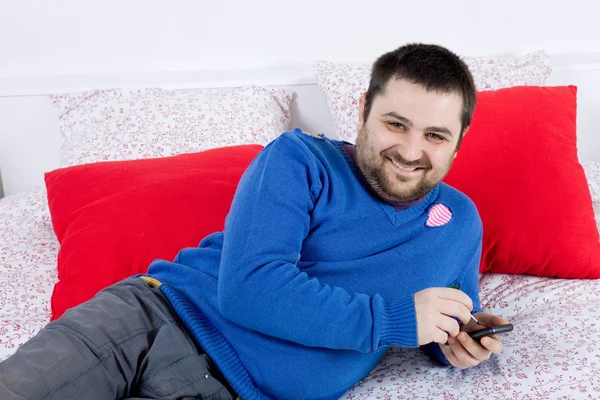 Young casual happy silly man in bed — Stock Photo, Image