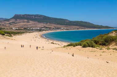 Tarifa, İspanya - Playa de Bolonia Plajı 'na yürüyen turistler, Tarifa, Cadiz' in bozulmamış beyaz kumsalı. Endülüs, İspanya.