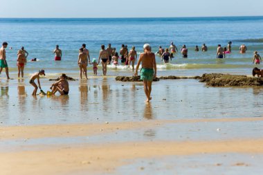 ALBUFEIRA, PORTUGAL - 21 Ağustos 2016: Albufeira 'nın ünlü Olhos de Agua plajındaki insanlar. Bu plaj Algarve 'nin ünlü turistik bölgesinin bir parçasıdır..
