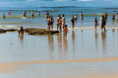 ALBUFEIRA, PORTUGAL - 21 Ağustos 2016: Albufeira 'nın ünlü Olhos de Agua plajındaki insanlar. Bu plaj Algarve 'nin ünlü turistik bölgesinin bir parçasıdır..