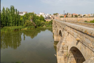 Merida, Spain. The Puente Romano, an old bridge still in use over the Guadiana River at Merida. Founded by ancient Rome in western Spain, the city preserves many buildings of that era.