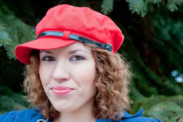 Young woman in a cap of red — Stock Photo, Image