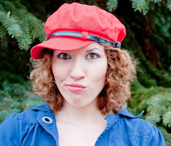 Young woman in a cap of red — Stock Photo, Image