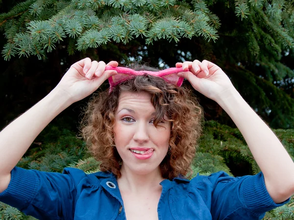 Young woman with a rim of ears on his head — Stock Photo, Image