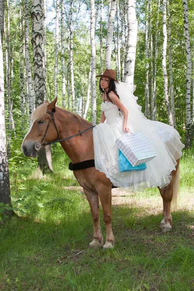Young woman in the dress of fiancee on a horse — Stock Photo, Image