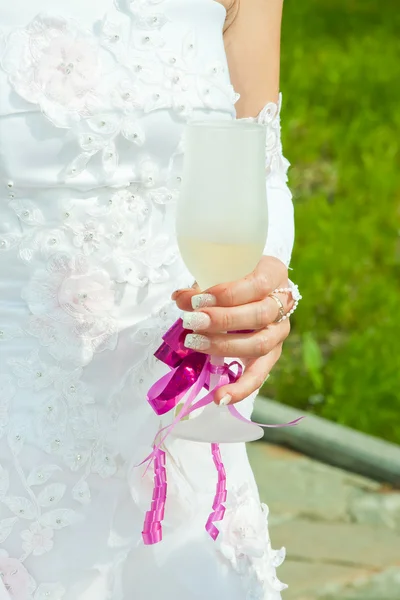Glass with champagne in the hands of fiancee — Stock Photo, Image