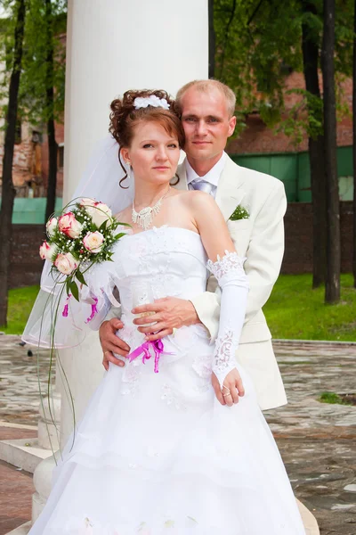 Happy groom and fiancee on a walk in a park — Stock Photo, Image