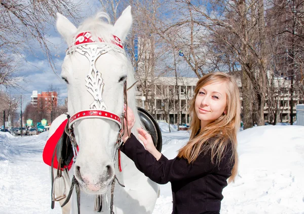 Woman with a horse in a winter park — Stock Photo, Image