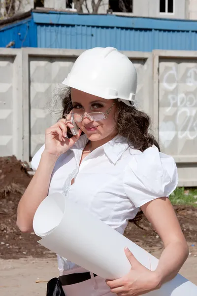 Young woman in a helmet and by documents in hands Stock Photo