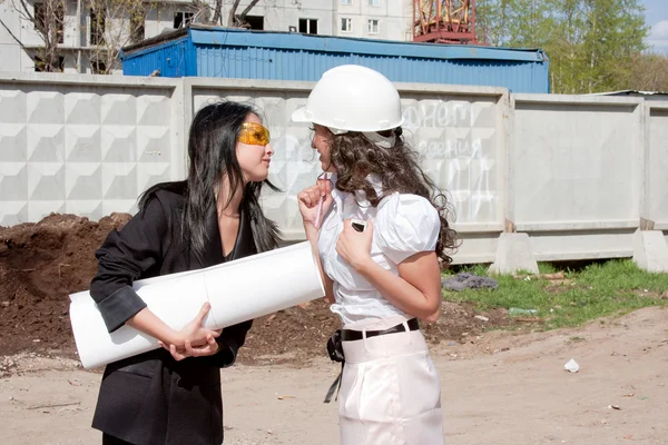 Two young business women on a background the built building Stock Image