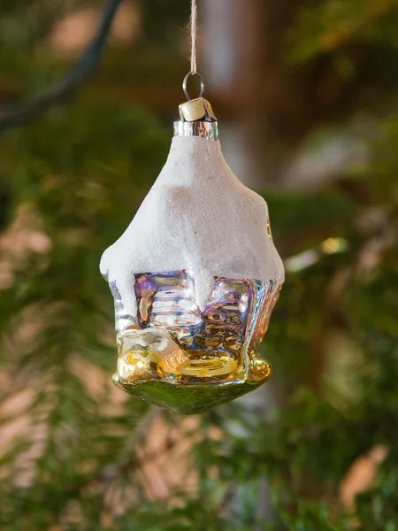 New-year toy a house hangs on a christmas tree — Stock Photo, Image