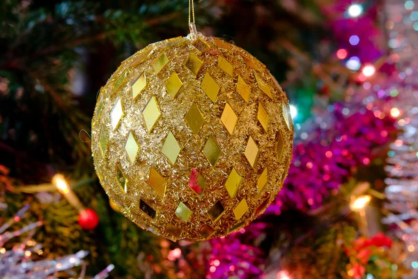 New-year toy a large ball hangs on a christmas tree — Stock Photo, Image