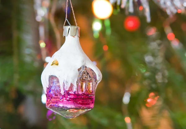 New-year toy a house hangs on a christmas tree — Stock Photo, Image